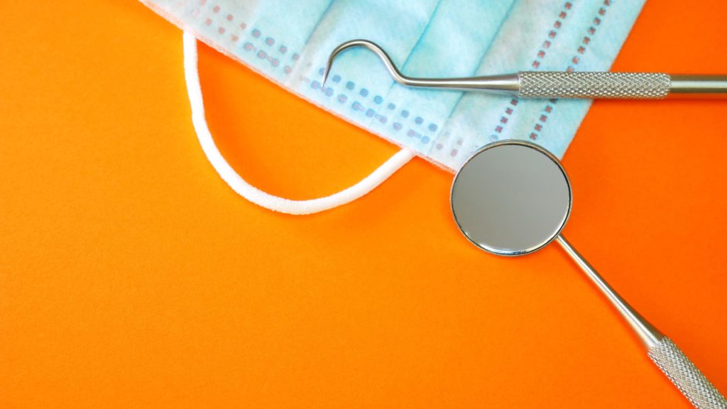 dental tools on top of a mask