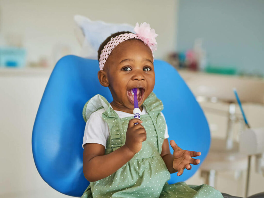 smiling baby with a toothbrush